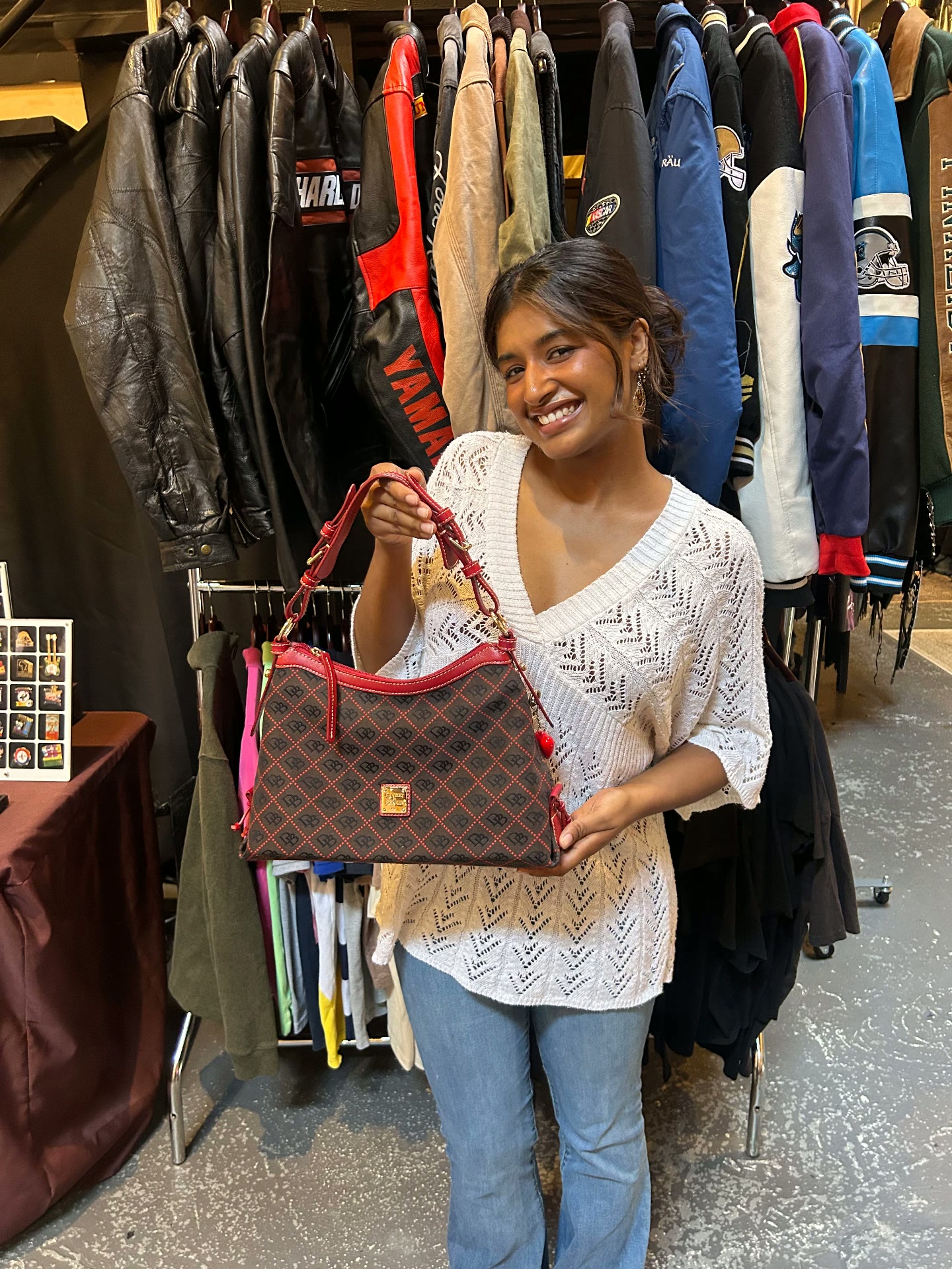 Guest showing a designer handbag at the booth